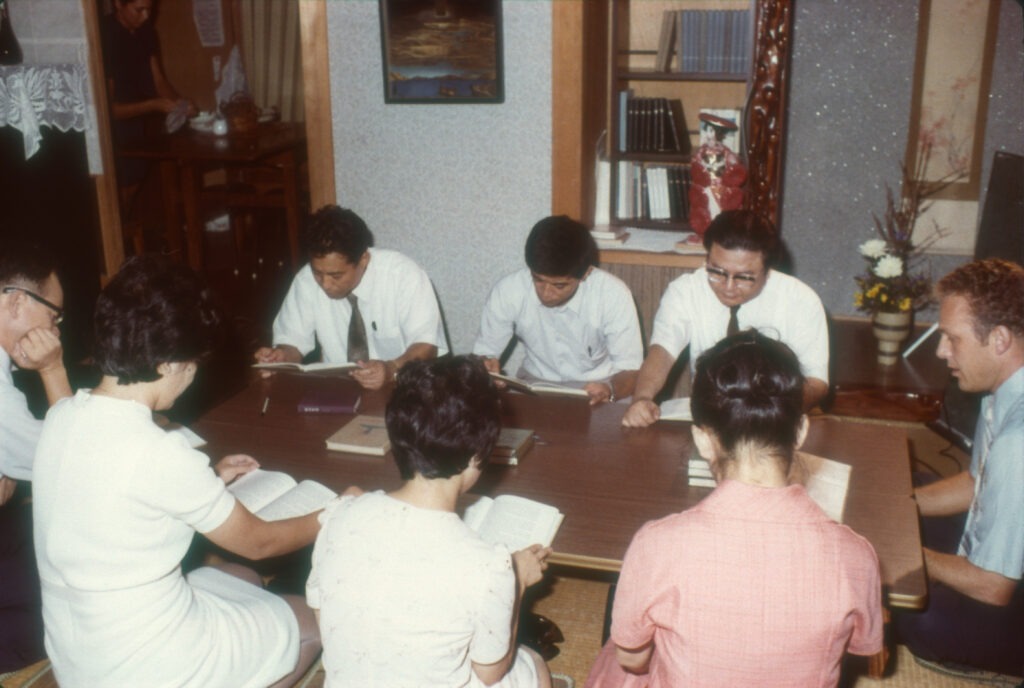 On right, Carl Liechty in an English language Bible study in December 1973 Kagashima, Japan. Photo courtesy of Mennonite Church USA.