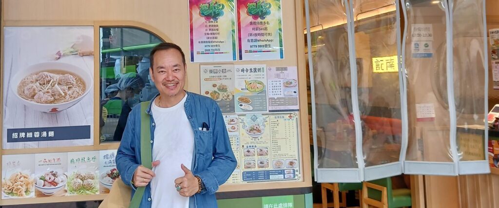 Andi Santoso standing in front of a restaurant