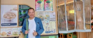 Andi Santoso standing in front of a restaurant