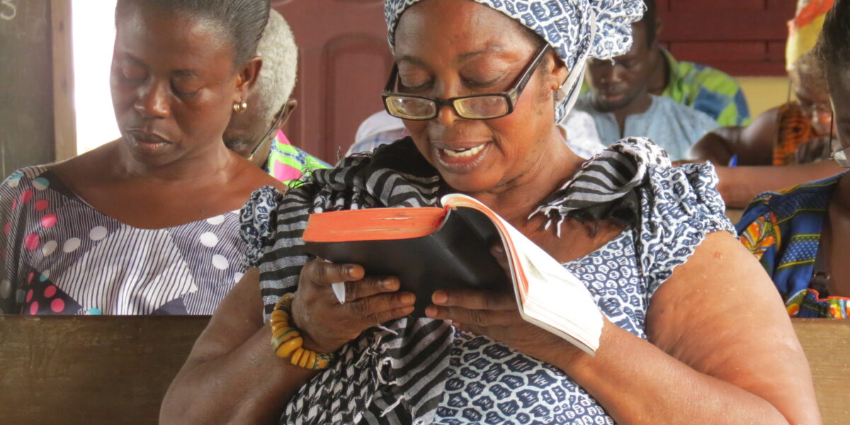 ​Bible classes on beach in Ghana taught by professors from Good News Theological College and Seminary. The wome nreading the Bible is Prophetess Mary Mensah from The Living Church of God. Photo by James R. Krabill.