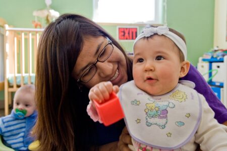 ​2007-08 Service Adventure participant Tania LaMotte plays with baby Aubrey at Learn and Play Child Development Center in Albuquerque. Learn and Play Child Development Center was one of the many service placments that welcomed Service Adventure participants over the years in the Albuquerque community. Photo by Cara Rufenacht.