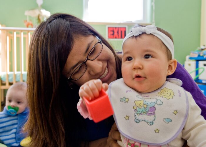 ​2007-08 Service Adventure participant Tania LaMotte plays with baby Aubrey at Learn and Play Child Development Center in Albuquerque. Learn and Play Child Development Center was one of the many service placments that welcomed Service Adventure participants over the years in the Albuquerque community. Photo by Cara Rufenacht.