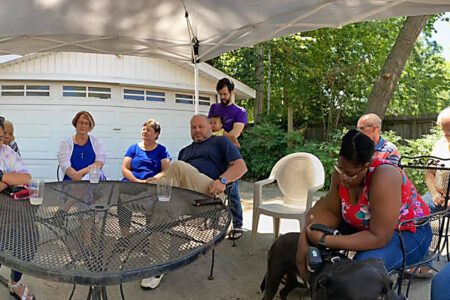 Pastor Horace McMillon and members of Open Door Mennonite Church participate in a blessing of Service Adventure participants Malachi Lind and Jocelyn Baker at the end of their time of service in Jackson