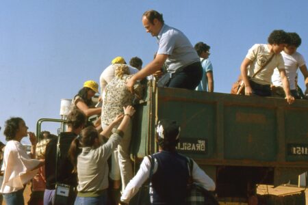 ​Erwin Rempel helps Venancia de Almeida climb into the vehicle that will carry 50 Mennonite youth from the Gama and Ceilandia congregation to a retreat. Photo provided.