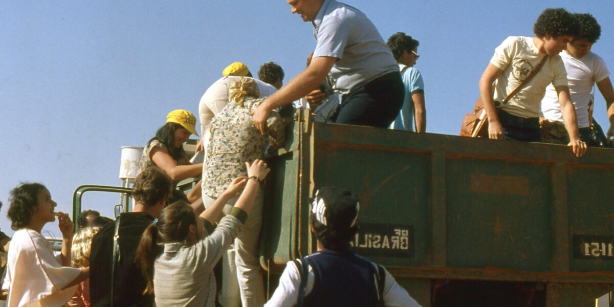 ​Erwin Rempel helps Venancia de Almeida climb into the vehicle that will carry 50 Mennonite youth from the Gama and Ceilandia congregation to a retreat. Photo provided.