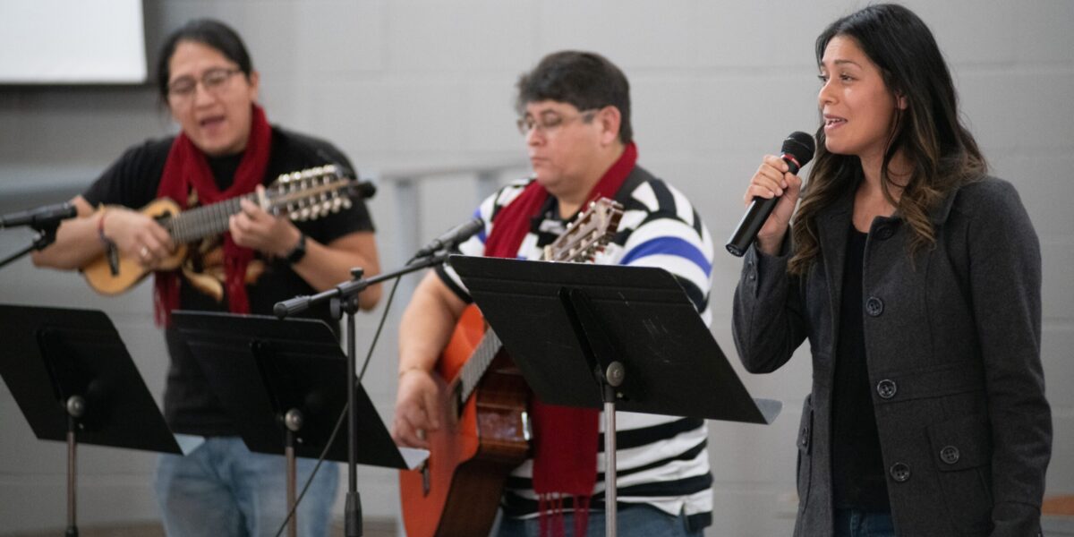 Mariela Sanchez (right) leads singing at Piedra Vida Mennonite Church