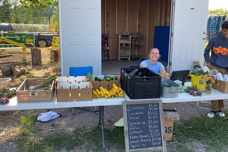 ​MVSer Elizabeth Breckbill volunteers at the food stand as part of her job with the Rio Grande Farm Park in Alamosa