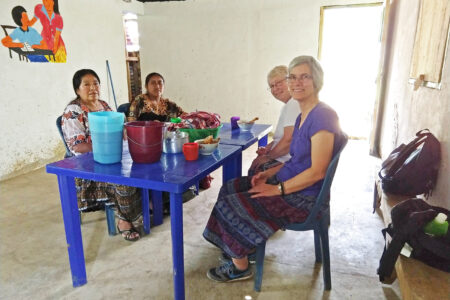 ​Left to right: Petrona Caz and Silvia Pop share a meal with Mission Network worker Deb Byler and Latin America area director Linda Shelly in the community of Oquebha