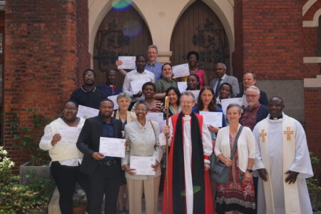 ​The first graduates of Holy Trinity Brussels' peace and conflict transformation program celebrate with Sharon Norton and Jean-Bosco Turahirwa (first row