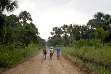 Three men walking down a path