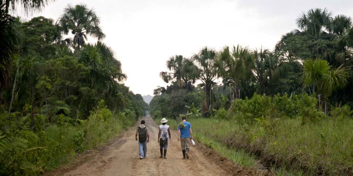 Three men walking down a path