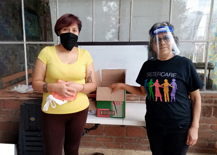 ​Ofelia García (right) enlists the help of a neighbor Elvia (left) in delivering food and other basic supplies in the neighborhood during the pandemic. Photo by Victor Pedroza.