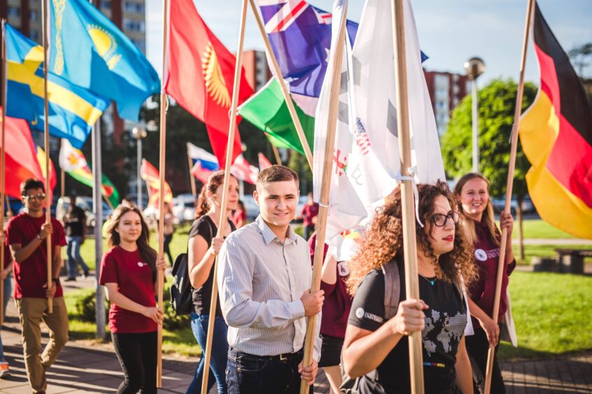 Some of LCC International University's students carry flags representing their home countries at the start of the 2021-22 academic year. Photo: LCC Corporate Communications Office