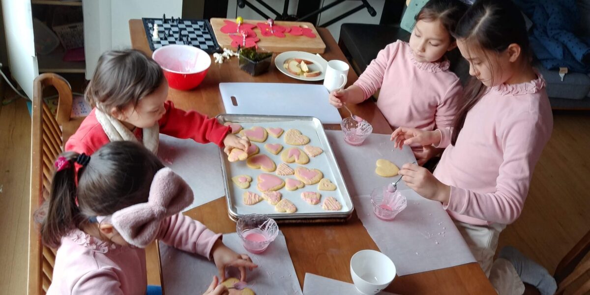 ​Jae Young Lee and Karen Spicher's children frosting Valentines Day cookies. Photo by Jae Young Lee.