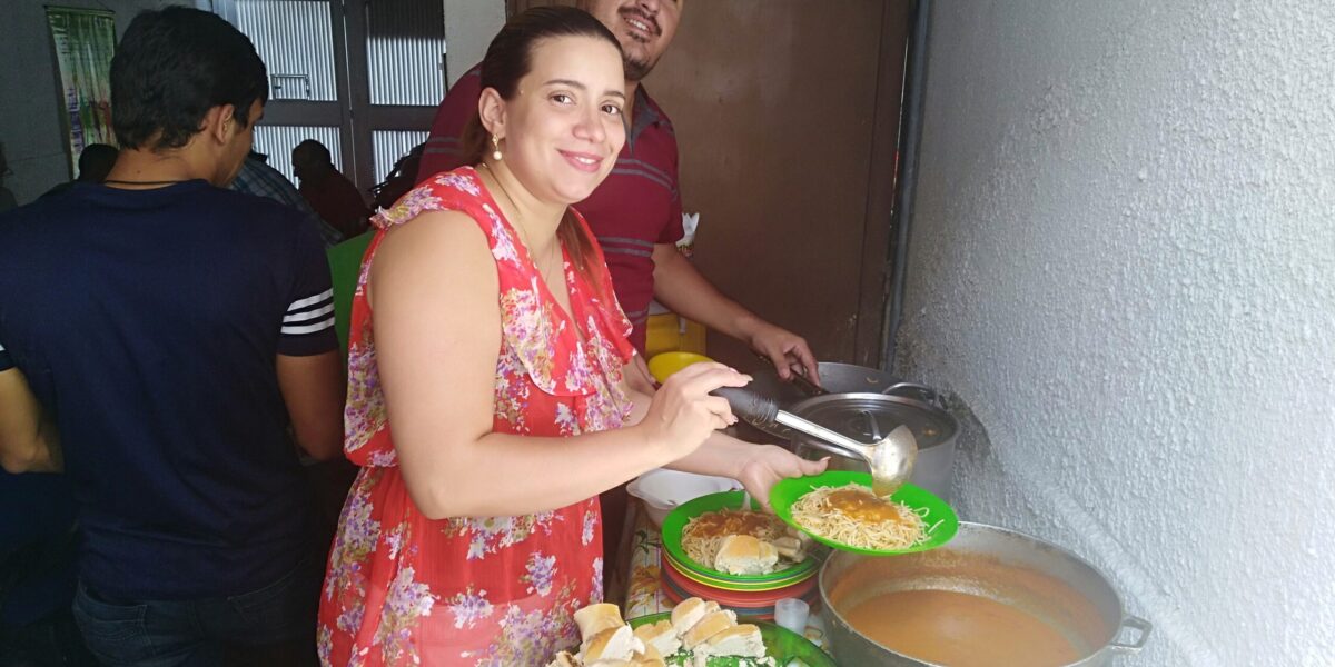 ​Helena Mirabal and Victor Mendez serve food for everyone after a service at the Mennonite church in El Paraíso neighborhood of Caracas in Venezuela. The church also shares food with their broader community