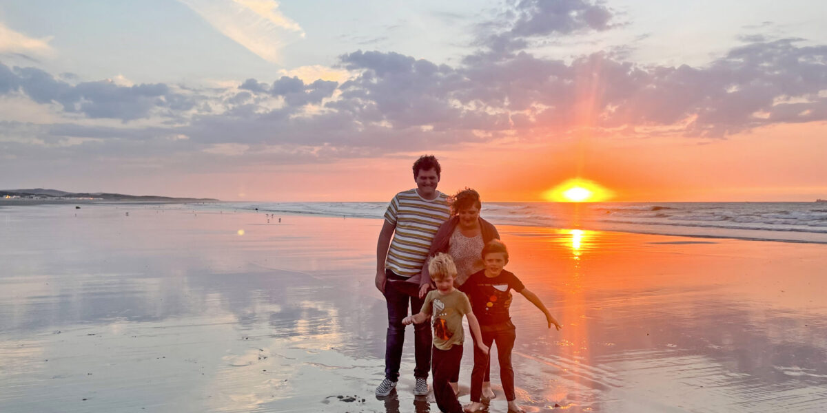 The Givens family enjoy an evening on the Calais, France, beach. This place of renewal is also a place of death for many people seeking a better life. Photographer: Joseph Givens.