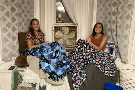 Roommates Luisa Dutchersmith and Lexie Coburn  in their cozy place — the bay window in their bedroom. Photo by Julia Yoder.