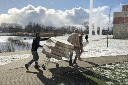 ​Students at LCC International University in Lithuania move mattresses to set up the gymnasium as a quarantine zone. Photo by Marlene Wall.