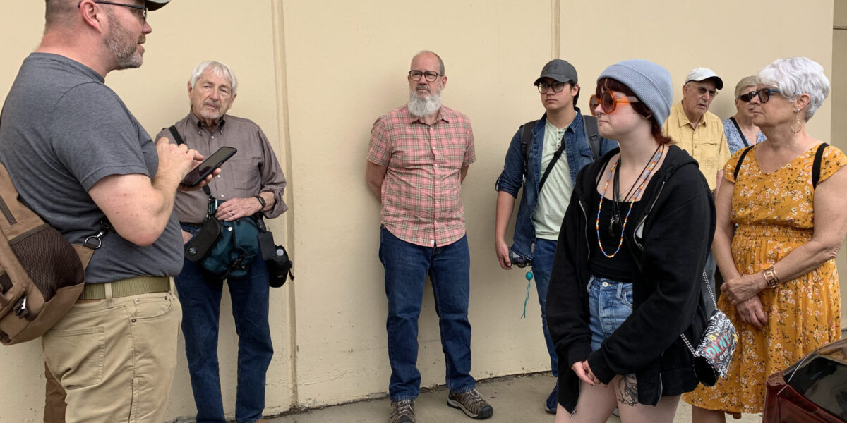 ​Pastor Hugh Hollowell Jr. of Open Door Mennonite Church leads the civil rights learning tour participants on a walking tour of Jackson