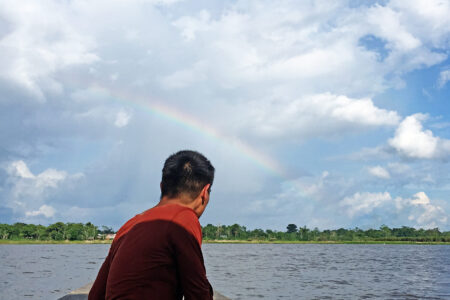 ​David Martinez on a boat during a Youth Venture trip in Peru. Photo by Marisa Smucker.