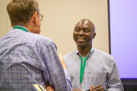 Nehemiah Chigoji (right) talks with a seminar attendee after co-leading the MennoCon21 seminar