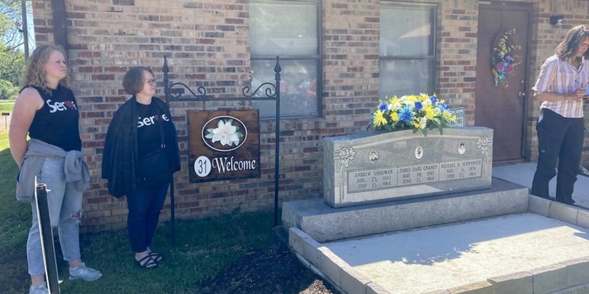 ​Participants in the Just Peace Pilgrimage civil rights tour stand near the marker commemorating Michael Schwerner