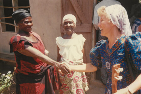 ​Salomey Akweley Gyan and Mary Adorko Lamptey welcome Julie Bender to the Achiaman Mennonite Church in Ghana circa 1991. Photographer: Philip Bender