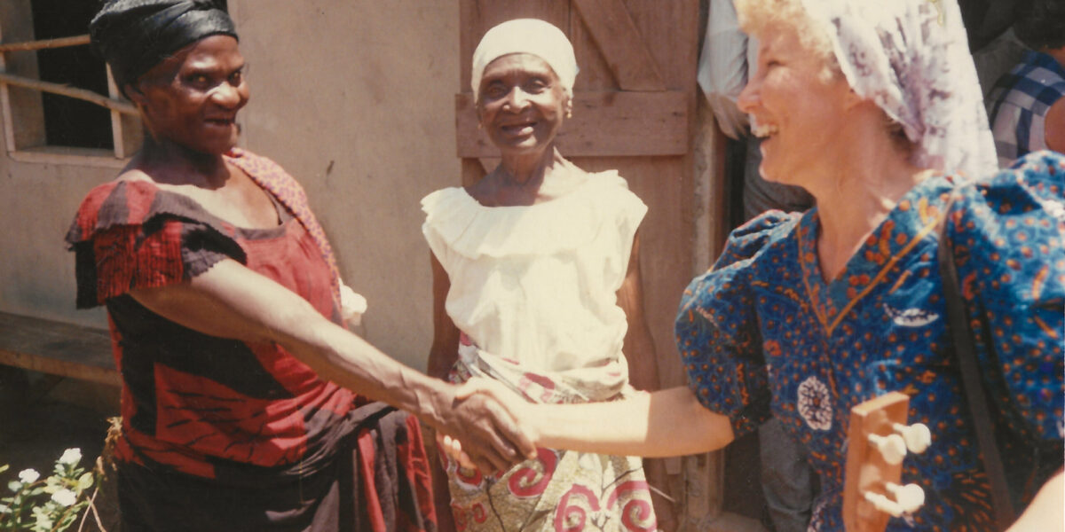 ​Salomey Akweley Gyan and Mary Adorko Lamptey welcome Julie Bender to the Achiaman Mennonite Church in Ghana circa 1991. Photographer: Philip Bender