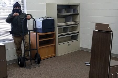 ​Naun Cerrato unloads office equipment for the office of La Posada at Sunnyside Mennonite Church in Elkhart