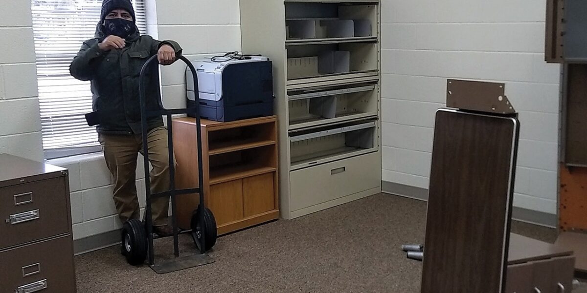 ​Naun Cerrato unloads office equipment for the office of La Posada at Sunnyside Mennonite Church in Elkhart