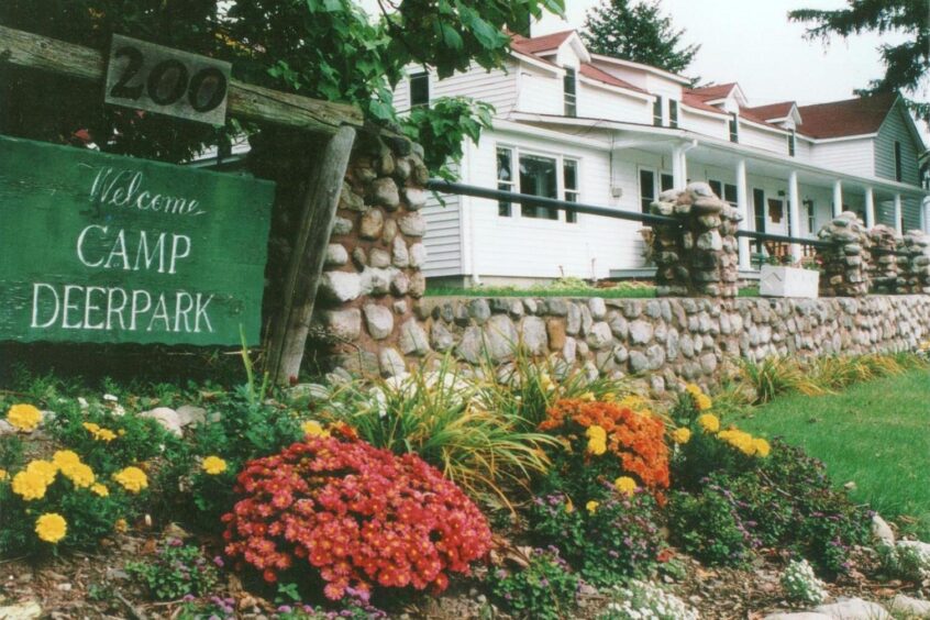 Leon-Yost-Photo-Spruce-Lodge-with-Sign-photo-cropped