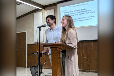 Caleb and Stephanie Schrock-Hurst present about their upcoming work in Taiwan to the crowd gathered at their fundraiser. Photo by Elizabeth Eby.