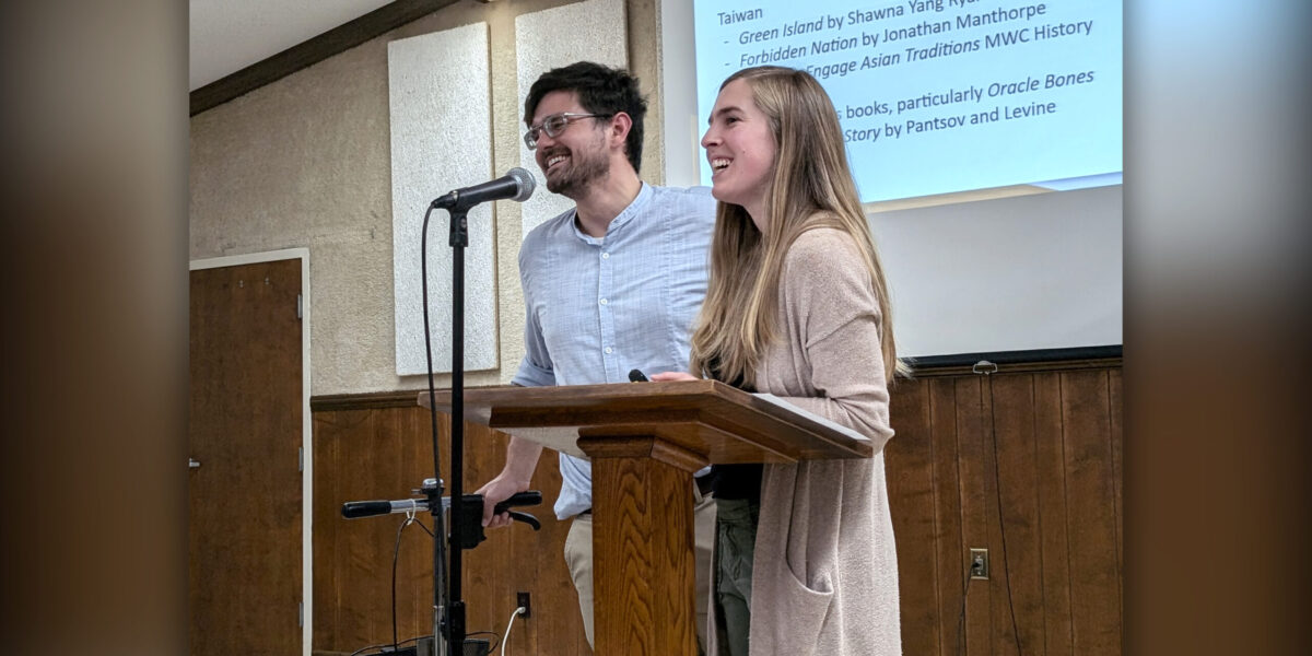 Caleb and Stephanie Schrock-Hurst present about their upcoming work in Taiwan to the crowd gathered at their fundraiser. Photo by Elizabeth Eby.