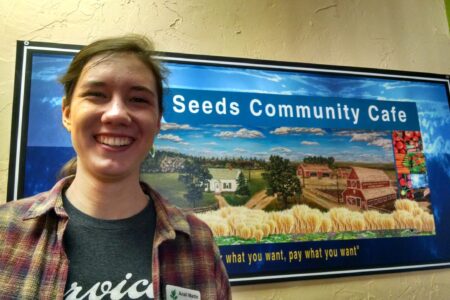 ​Anali North Martin stands outside her placement at Seeds Community Café. Picture taken by Susan Nisly. Click on image for high resolution version.