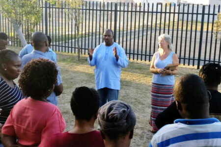 ​Oscar Siwali addresses Lwandle Leaders Community Conflict Transformation workshop participants with Kathryn Smith Derksen. Photo provided.