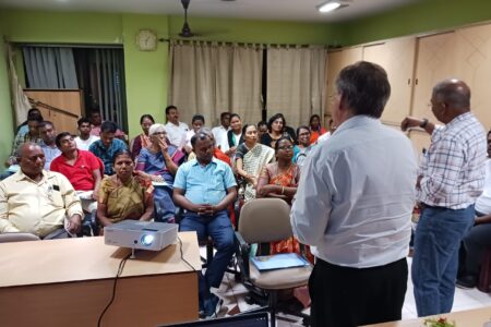 David Boshart and Vikal Pravin Rao look on while Sangita Tigga of Bihar Mennonite Mandli conference reports from a small group.