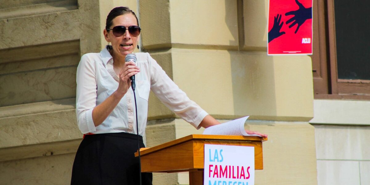 ​Lisa Koop addressing a Families Belong Together rally. Photo by Darrin Eichorn. 