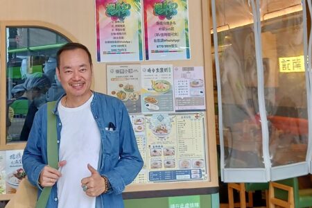 Andi Santoso standing in front of a restaurant