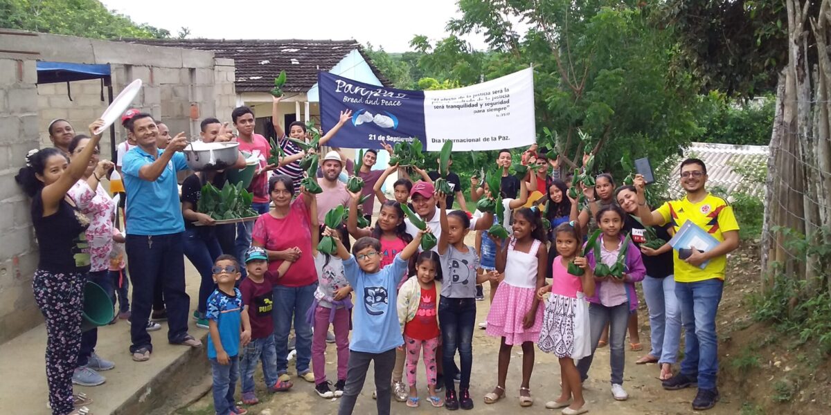 ​These youth and children hand out meals on the International Day of Peace as part of the Colombia Mennonite Church's celebration called "Pan y Paz" (Bread and Peace). This distribution of food symbolizes that justice making (everyone needs something to eat) is integral to peace-making. Photo by Kelly Frey Martin.