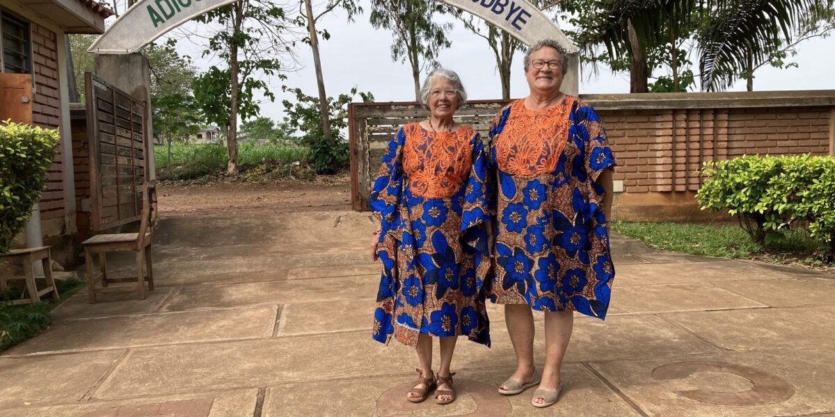 From left, Maria and Barb Thuma pose after Sunday church service on their last day in Allada. Their bespoke dresses were gifted to them the day before as a going-away present from La Casa Grande Director Bienvenu Kadja and his wife Chimene Kadja, a member of the staff.